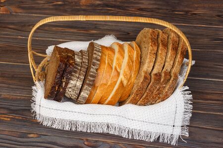 Fresh sliced bread and loaf on bascet, closeup.の写真素材