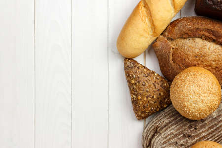 assortment of baked bread on wood table. top view with copy space.の写真素材