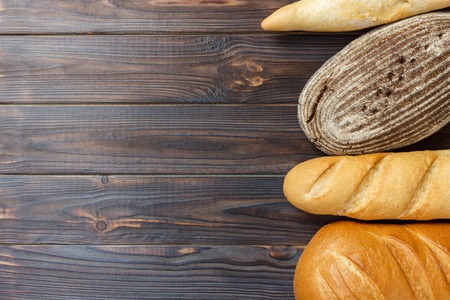 fresh Bread assortment on wooden surface background.の写真素材