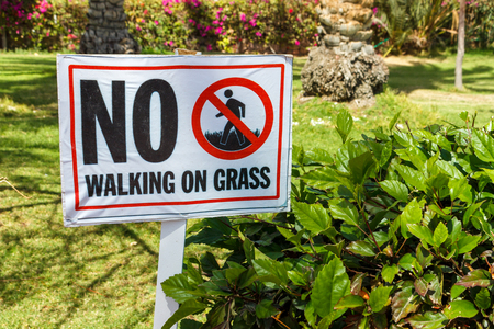 No walking on grass warning sign in the garden.の写真素材