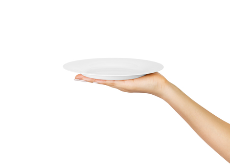 Blank empty round plate in female hand. perspective view, isolated on white background.の写真素材