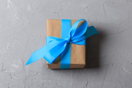 Gift box in craft paper on gray background.の写真素材