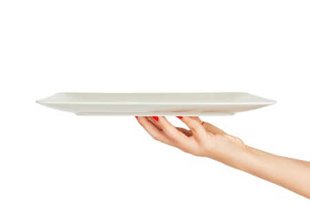 Blank white matte rectangular plate in female hand. perspective view, isolated on white background.の写真素材