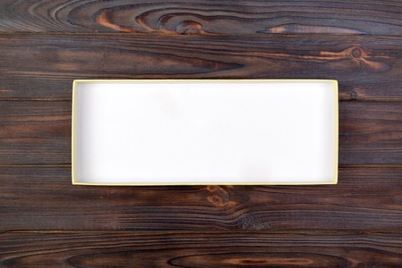 Open Cardboard white box on a dark table, wooden background. top view.の写真素材