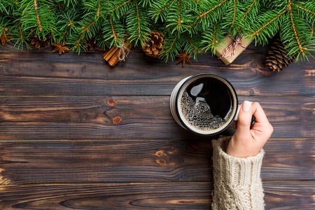 Mug of coffee on black wooden christmas background. top view, copy space.の写真素材