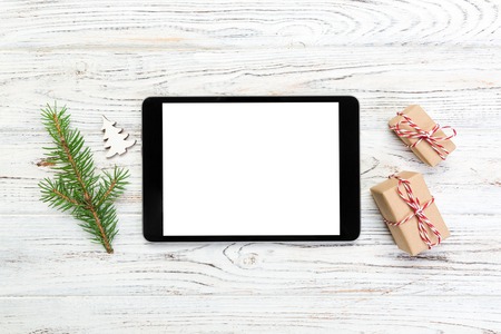 Digital tablet mock up with rustic Christmas wooden background decorations for app presentation. top view with copy space.の写真素材