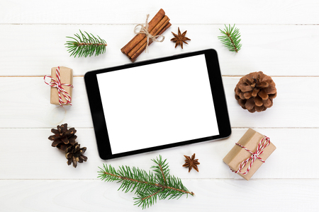 Digital tablet mock up with rustic Christmas wooden background decorations for app presentation. top view with copy space.の写真素材