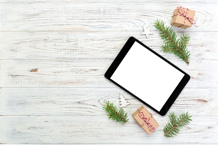 Digital tablet mock up with rustic Christmas wooden background decorations for app presentation. top view with copy space.の写真素材