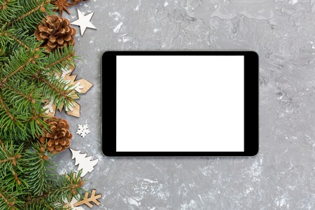 Digital tablet mock up with rustic Christmas gray cement background decorations for app presentation. top view with copy space.の写真素材