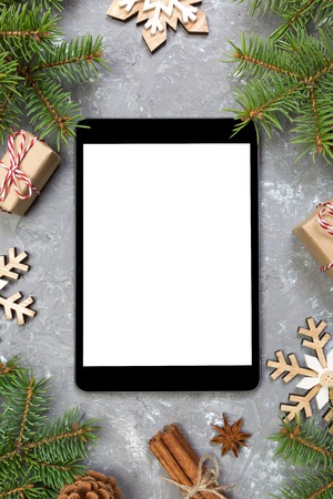 Digital tablet mock up with rustic Christmas gray cement background decorations for app presentation. top view with copy space.の写真素材