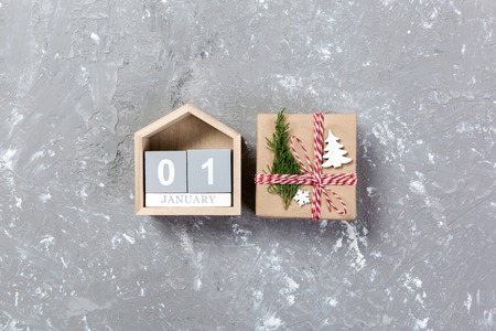 Calendar with date 1 january and gift boxes on color background. Christmas concept.の写真素材