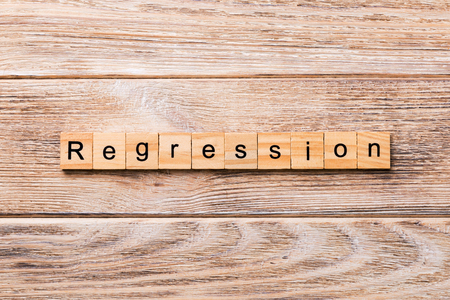 regression word written on wood block. regression text on wooden table for your desing, concept.の写真素材