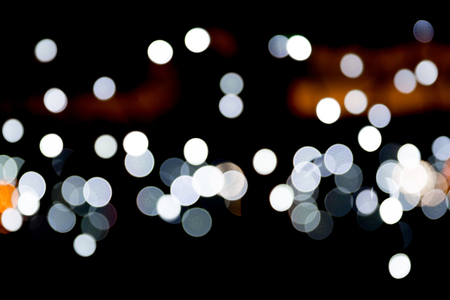 Abstract bokeh of white city lights on black background. defocused and blurred many round light.の写真素材