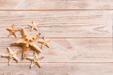 Starfish, seashells on a wooden table, top view, flat lay with copy space.の写真素材
