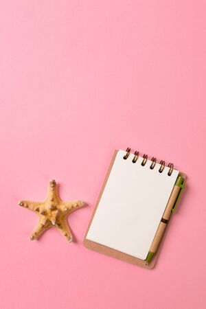 blank notebook with seashell for summer holiday pink background , Top view Flat lay concept.の写真素材