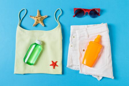 Flat lay composition with Beach accessories on blue color background. Summer holiday background....