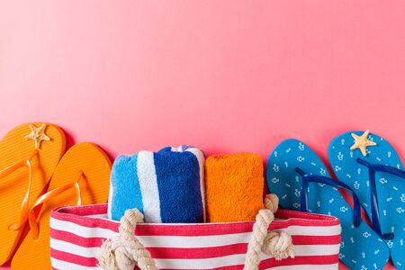 Summer bag background with copy space. Flat lay photo on color table, travel concept. Free space for text, mock-up.の写真素材