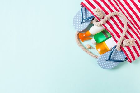 Summer bag background with copy space. Flat lay photo on color table, travel concept. Free space for text, mock-up.の写真素材