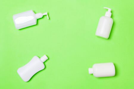 Set of White Cosmetic containers isolated on green background, top view with copy space.の写真素材