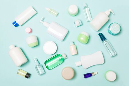 Group of plastic bodycare bottle Flat lay composition with cosmetic products on blue background empty space for   design. Set of White Cosmetic containers, top view with copy space.の写真素材