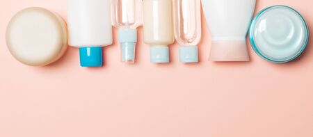 Top view of cosmetics bottles on pink background. Skin care concept with space for your design.の写真素材