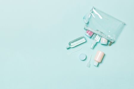 Top view of means for face care: bottles and jars of tonic, micellar cleansing water, cream, cotton pads on bluebackground. Bodycare concept with empty cpace for your ideas.の写真素材