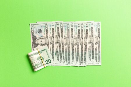 Top view of lying 20 dollar banknotes in one line on colorful background. Close up of money saving concept.の写真素材