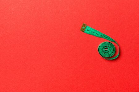 Top view of measure tape curtailed into a spiral with copy space. Concept of sewing accessory or...
