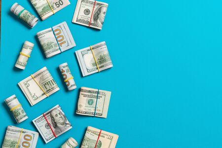 Pile of one hundred US Dollar Bills money on colored background top wiev with copy space for your...