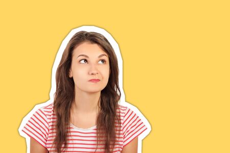 Close-up portrait of a casual pretty young smiling girl thinking about something. emotional girl Magazine collage style with trendy color.の写真素材