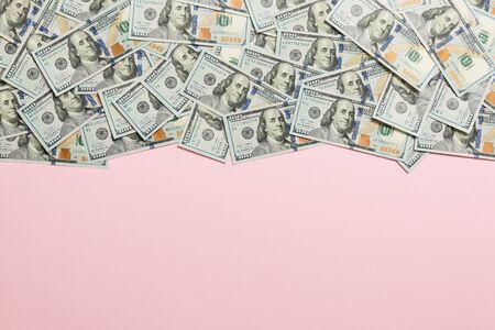 Top view banknotes on colored desk with copy space on top. one hundred dollar bills with stack of...