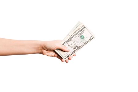Female hand giving money on white isolated background. Top view of dollar banknotes. Bribe concept....