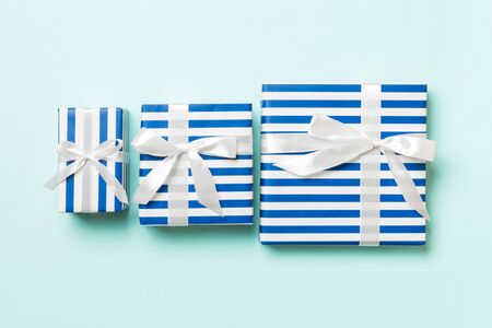 Top view present box with White bow on blue background.の写真素材