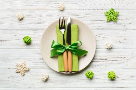 Holiday composition of Christmas dinner on wooden background. Top view of plate, utensil and festive...