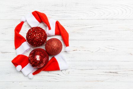 Top view of festive winter composition on wooden background with empty space for your design. Christmas baubles and decorations. New Year concept.