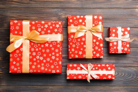 Top view of christmas or other holiday handmade present box package, flat lay dark wooden background...