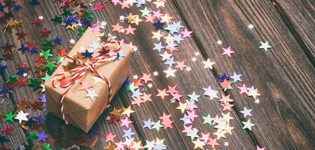 gift box with star shape decor on white wood table background. Toned.の写真素材