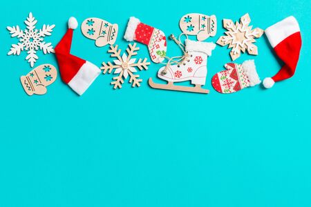 Top view of Christmas decorations and Santa hats on blue background. Happy holiday concept with copy space.の写真素材
