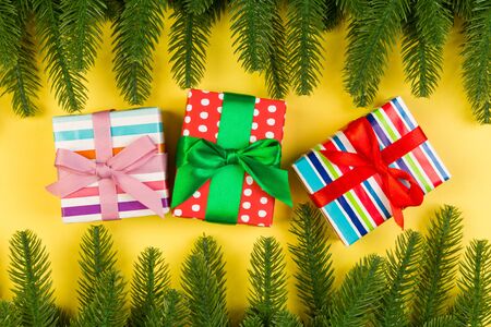 Top view of colorful holiday background made of fir tree and gift box. Happy New Year concept with copy space.の写真素材