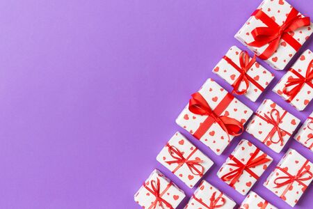 Holiday composition of gift boxes with red hearts on colorful background with empty space for your design. Top view of Valentine's Day concept.の写真素材