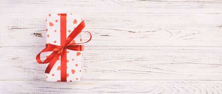 Valentine or other holiday handmade present in paper with red hearts and gifts box in holiday...