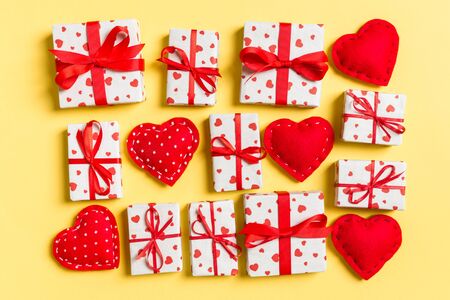 Top view of white gift boxes and red textile hearts on colorful background. Valentine's Day concept.の写真素材