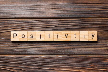 positivity word written on wood block. positivity text on wooden table for your desing, concept.の写真素材