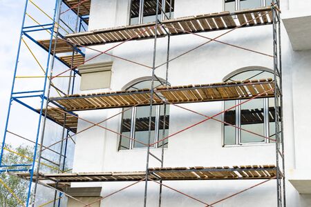 Extensive scaffolding for building a new house. Constraction of platforms for building works.