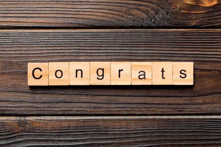 Congrats word written on wood block. Congrats text on wooden table for your desing, Top view concept.の写真素材