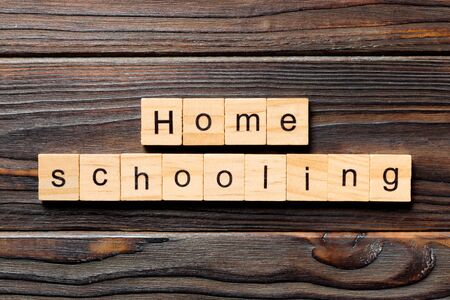 Homeschooling word written on wood block. Home schooling text on table, concept.の写真素材