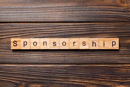 Sponsorship word written on wood block. Sponsorship text on table, concept.の写真素材