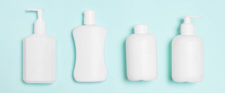 Set of White Cosmetic containers isolated on blue background, top view with copy space. Group of...
