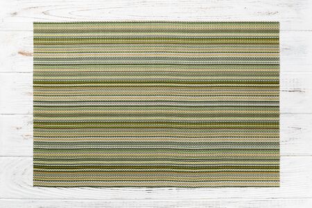 Top view of green place mat for a dish. Wooden background with empty space for your design.の写真素材