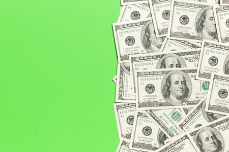 One hundred dollar banknotes on colored background top view, with empty place for your text business...